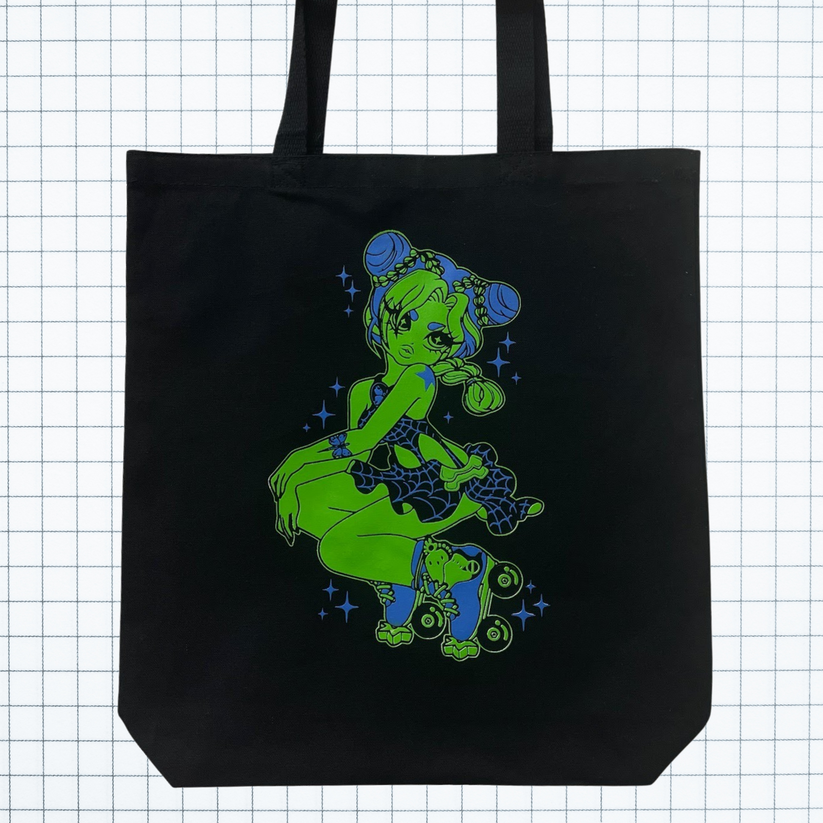 Black tote with blue and green screenprinted graphic. Graphic is fan art of Jolyne from the anime Jojo's Bizarre Adventure. Tote is on white grid background.